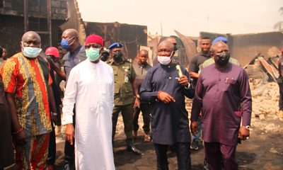 Okowa (in white) inspecting level of destruction