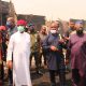 Okowa (in white) inspecting level of destruction