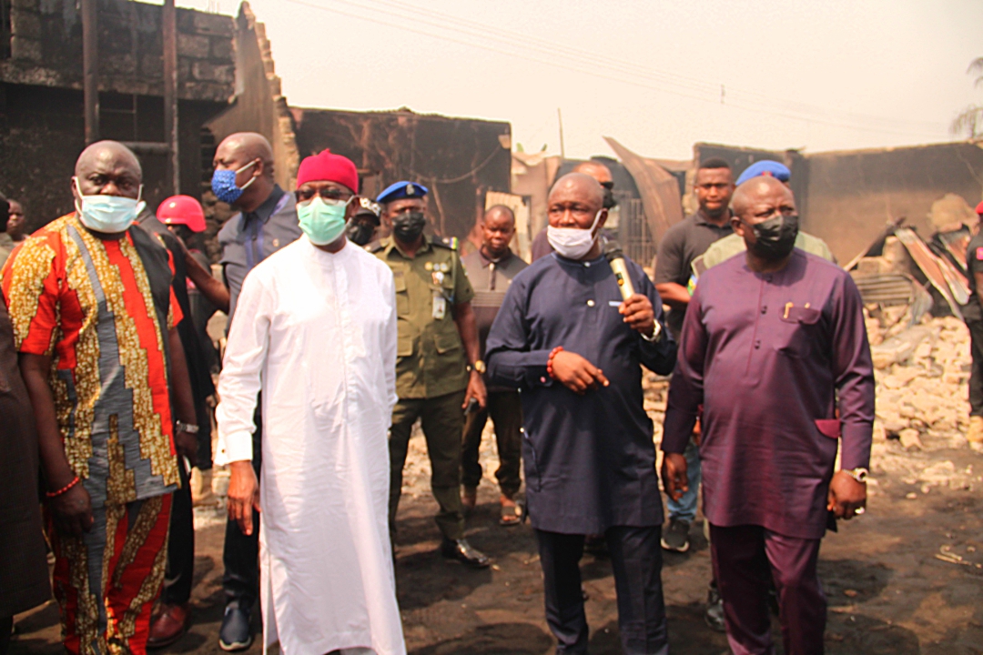 Okowa (in white) inspecting level of destruction